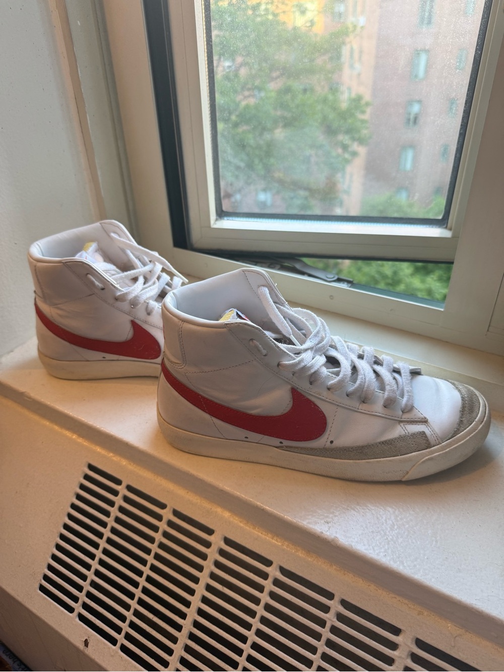 Nike White High-Top Sneakers with Red Swoosh